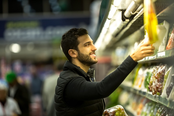 Young man buying products at the supermarket